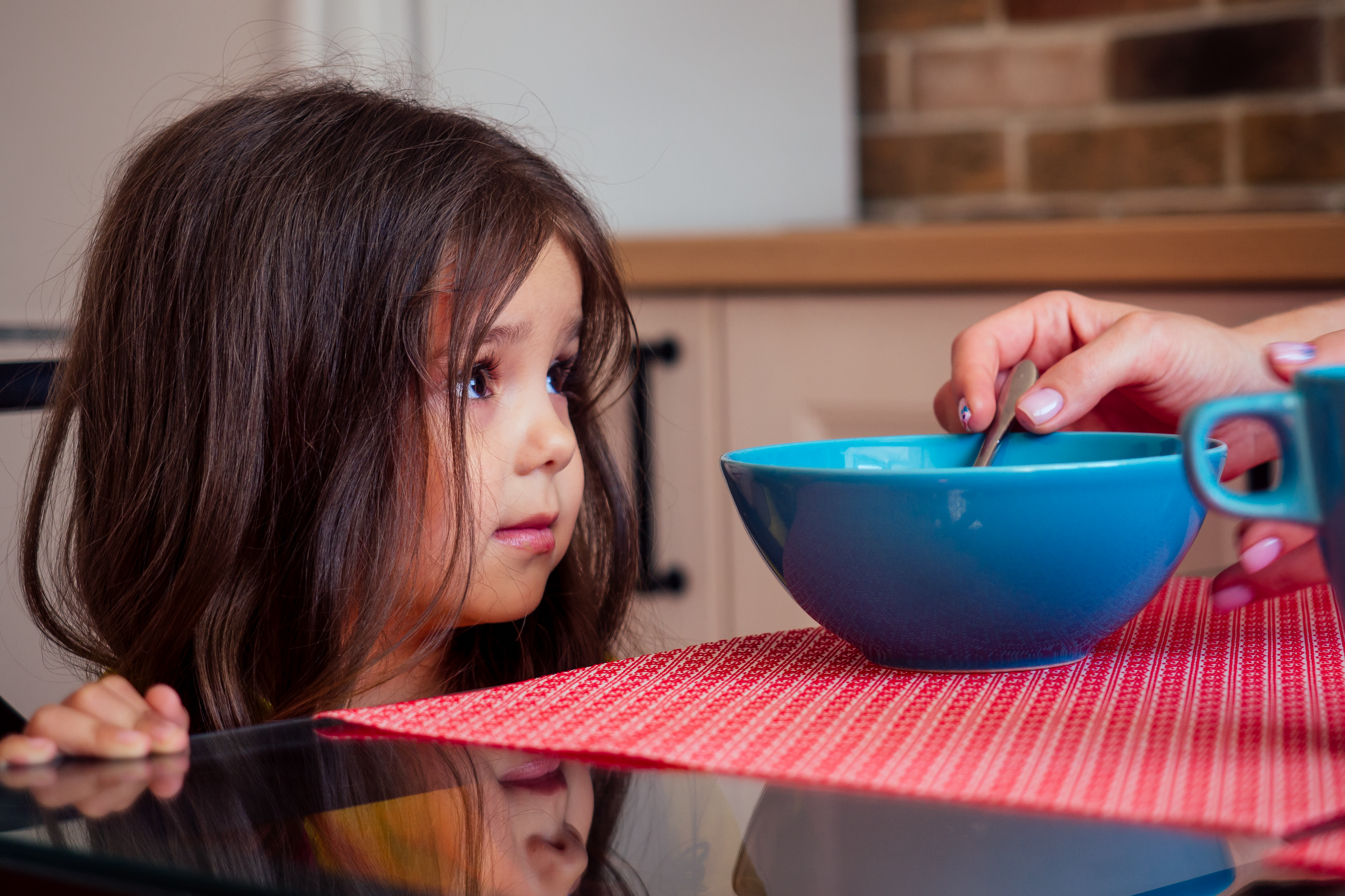 beautiful caucasian girl does not want to eating kitchen with her sister